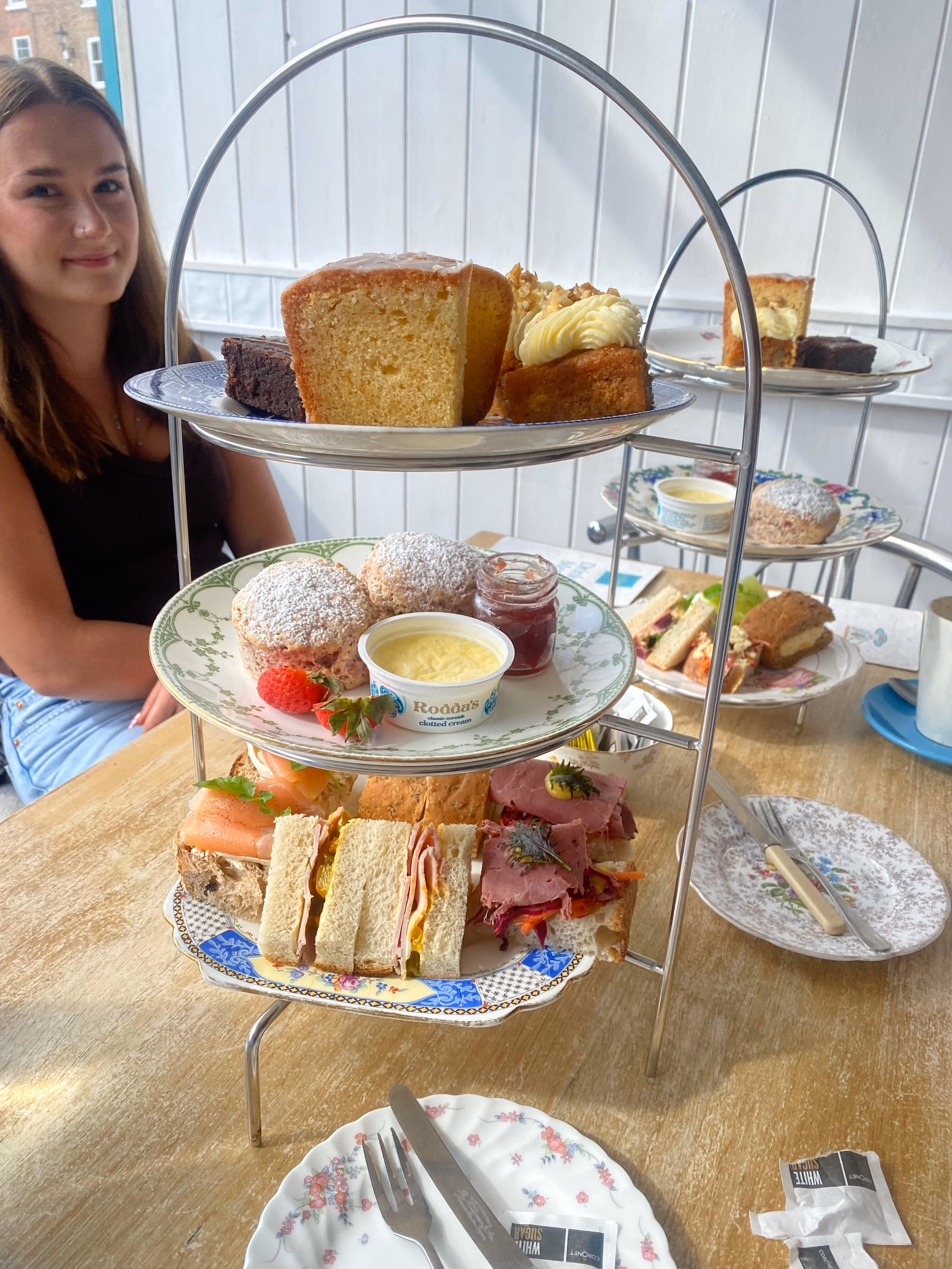 Afternoon tea at Tea Time: a three-tier stand of finger sandwiches, scones, clotted cream and homemade cakes on vintage crockery